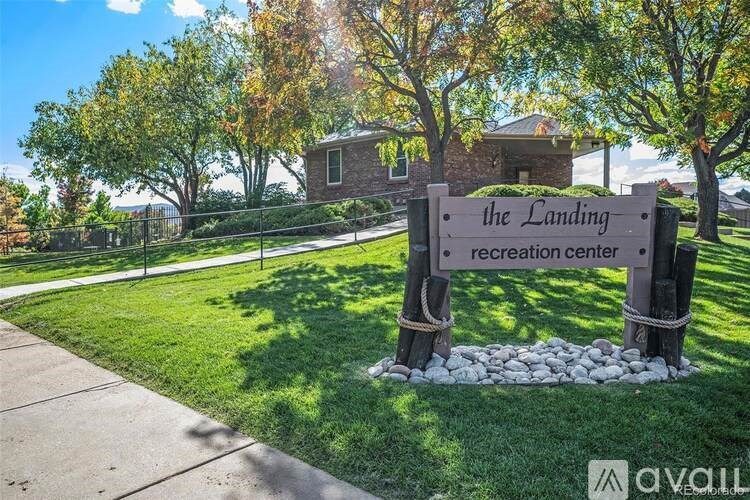 A sign for The Landing recreation center stands in front of a grassy area.