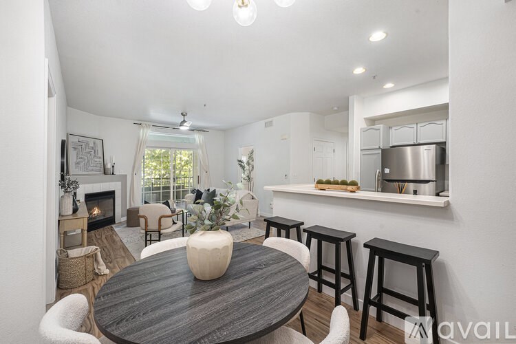 A modern dining room with a wooden table and chairs.