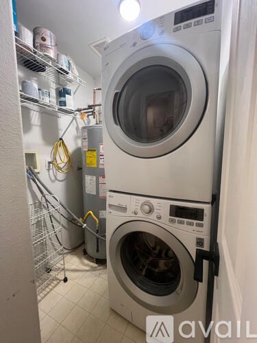A washing machine is in a small laundry room.