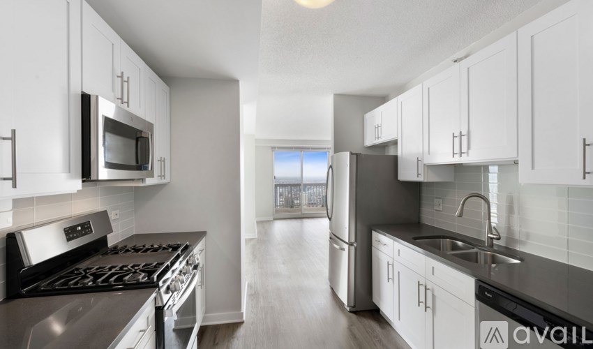 A kitchen with white cabinets and stainless steel appliances.