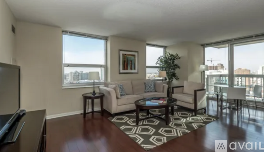 A living room with a couch, coffee table, and a large window.