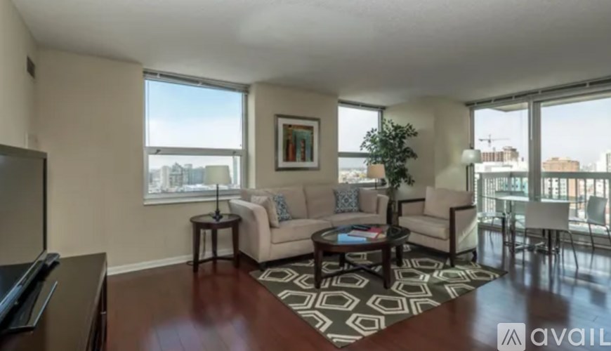A living room with a couch, coffee table, and a large window.