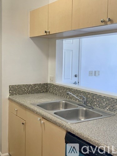 A kitchen with a sink and cabinets.