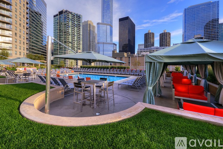 A rooftop pool area with a view of the city skyline.