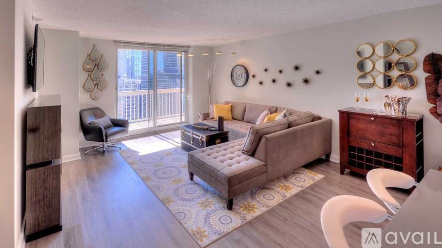 A living room with a couch, chair, and a television.