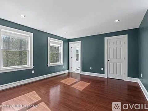 A room with wood flooring and white doors.