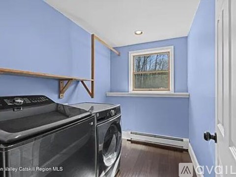 A laundry room with a washer and dryer.