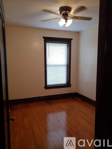 A room with a ceiling fan and a window.