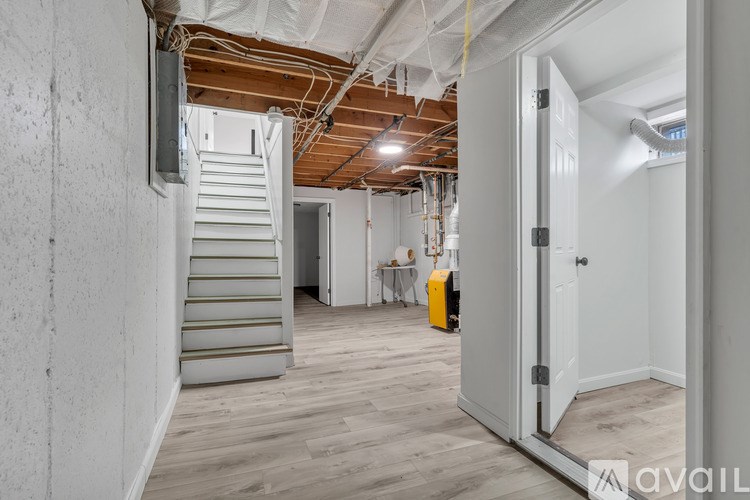 A room with a staircase and wooden floors.