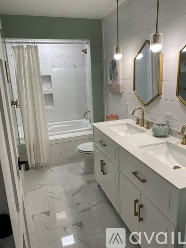 A bathroom with a white sink and a white toilet.