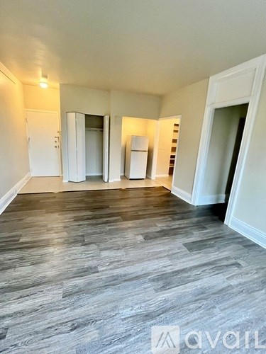 A room with a wooden floor and white walls.