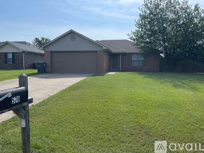 A house with a garage and a mailbox with the number 570 on it.