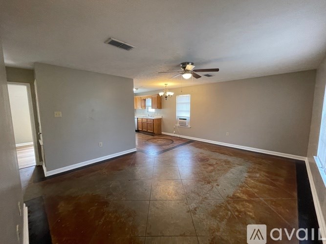 A room with a ceiling fan and a window.