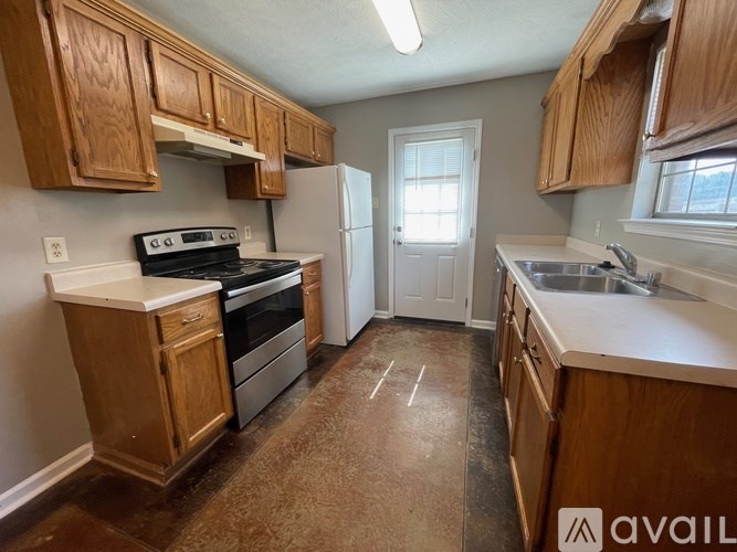 A kitchen with wooden cabinets and a white refrigerator.