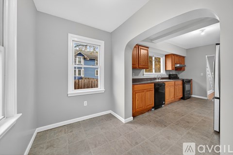 A kitchen with wooden cabinets and a fridge.