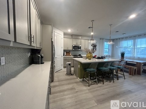 A kitchen with a dining table and chairs.