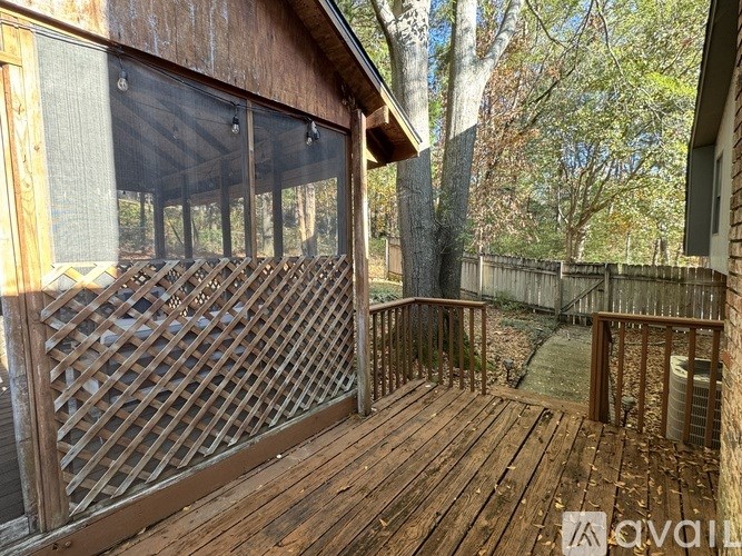 A wooden deck with lattice fencing and a screened-in area.