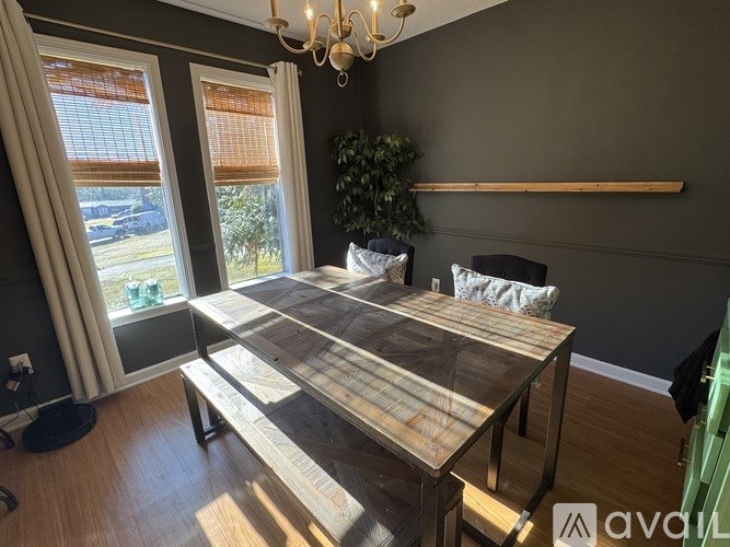 A dining room with a wooden table and chairs.
