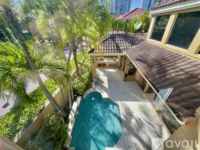 A tiled roofed house with a pool in the middle.