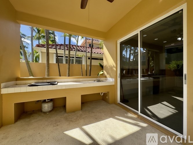 A sunny room with a bench and a fan.