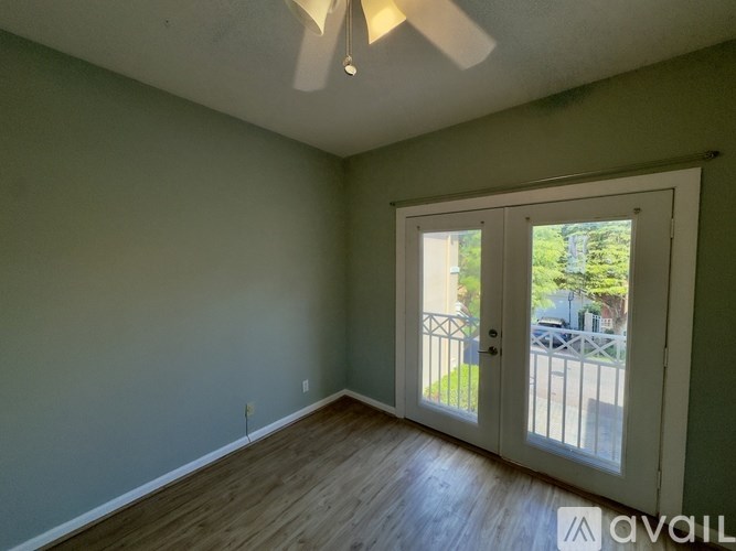 A room with a sliding glass door leading to a backyard.