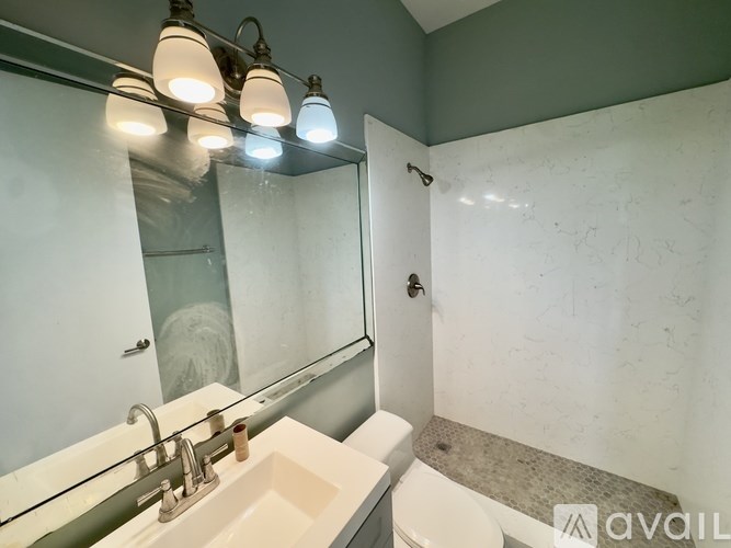 A bathroom with a sink, mirror, and tub.