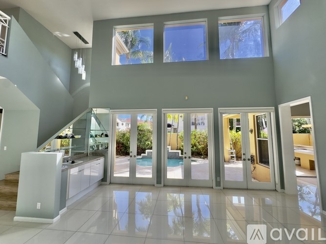 A spacious interior with a pool visible through the glass doors.