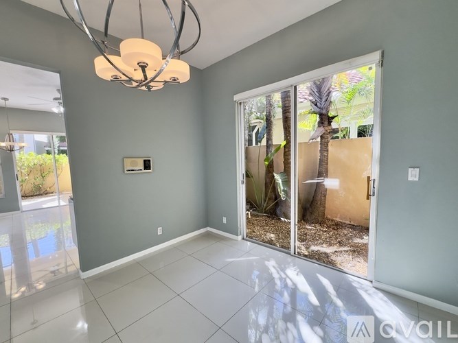 A room with a grey wall and a chandelier.