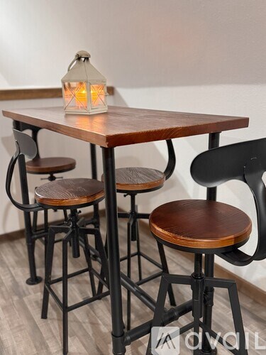 A table with a lantern and two chairs.