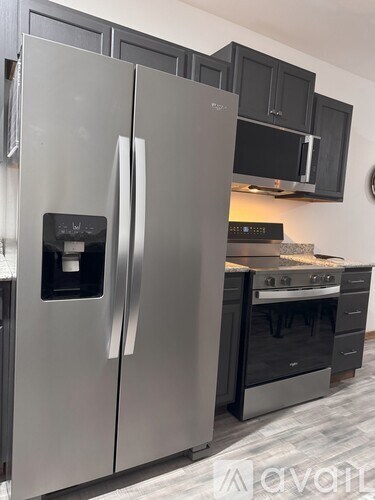 A stainless steel refrigerator with a water and ice dispenser in the door.