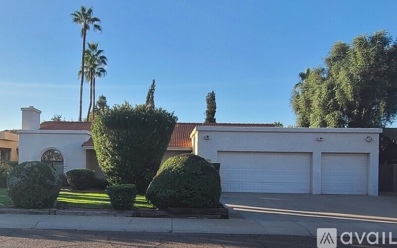 A house with a white garage door is for sale.
