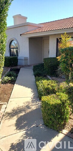 A house with a white exterior and a red tile roof.