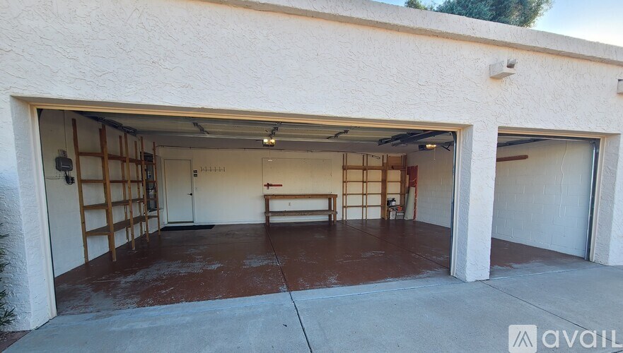 A garage with a bench inside and a wall on the left side.