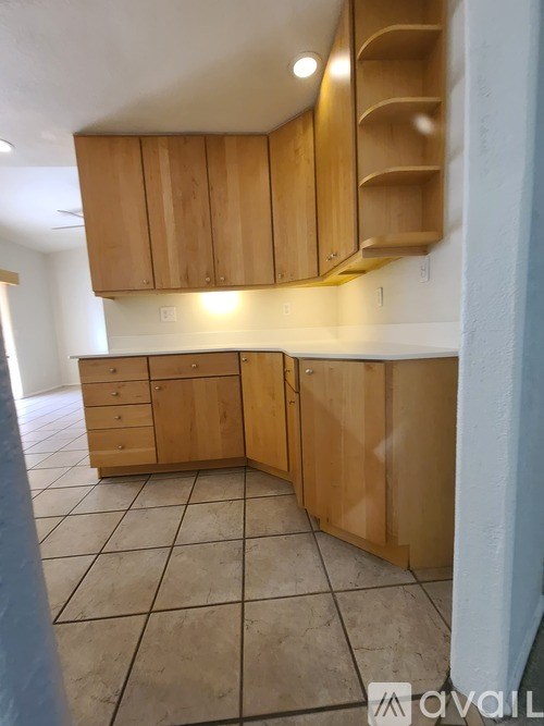 A kitchen with wooden cabinets and drawers.