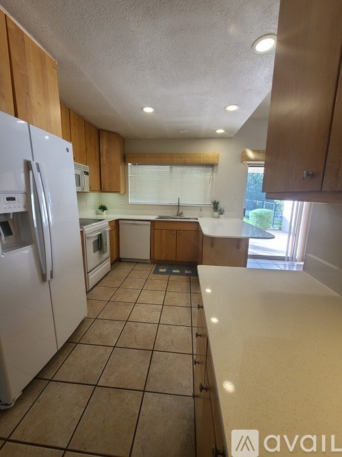 A kitchen with a refrigerator, oven, and microwave.