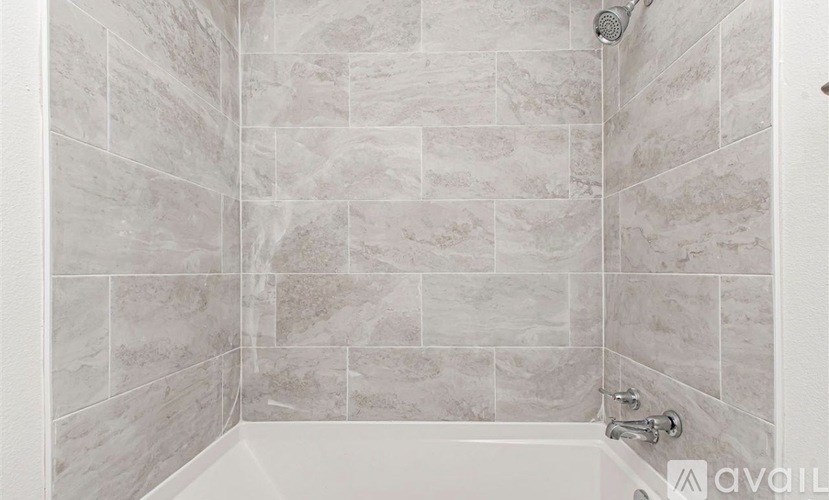 A bathroom with a tiled shower area.