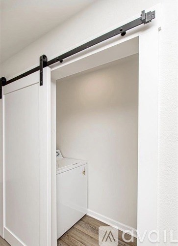 A white bathroom with a toilet and a sliding door.