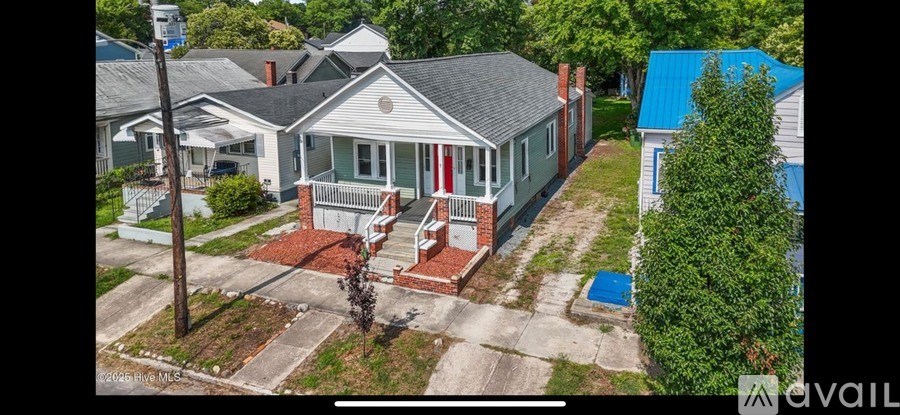 A house with a red door and a porch.