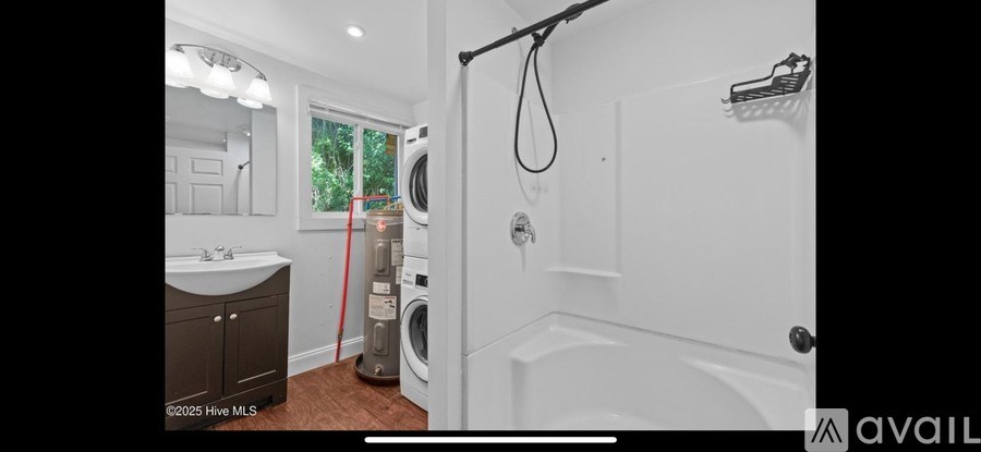 A bathroom with a washer and dryer in it.