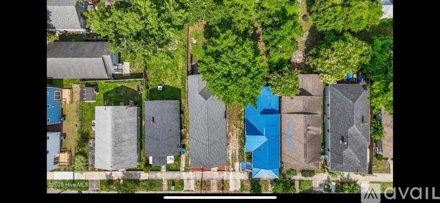 A bird's eye view of a residential area with houses and trees.