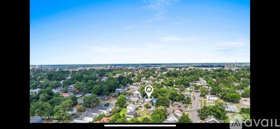 A bird's eye view of a residential area with a clear blue sky.