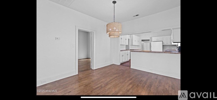 A large open room with a kitchen area in the background.