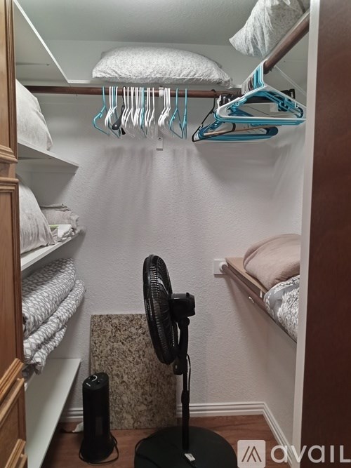 A small room with a round black object on the floor.