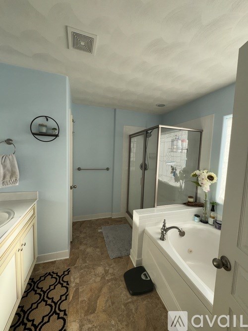 A bathroom with a white sink and a white bathtub.