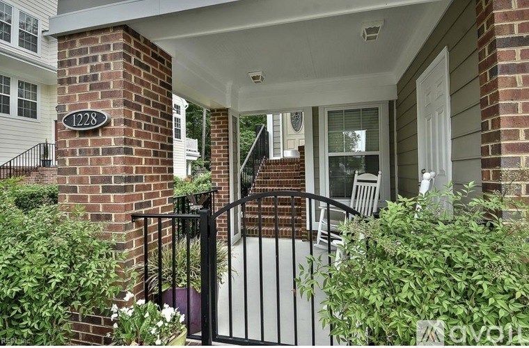 A house number 1228 is visible on a brick pillar.