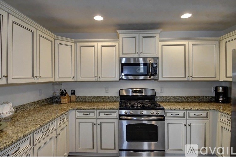 A kitchen with granite countertops and stainless steel appliances.