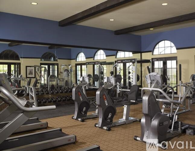 A gym with treadmills, weights, and exercise machines.