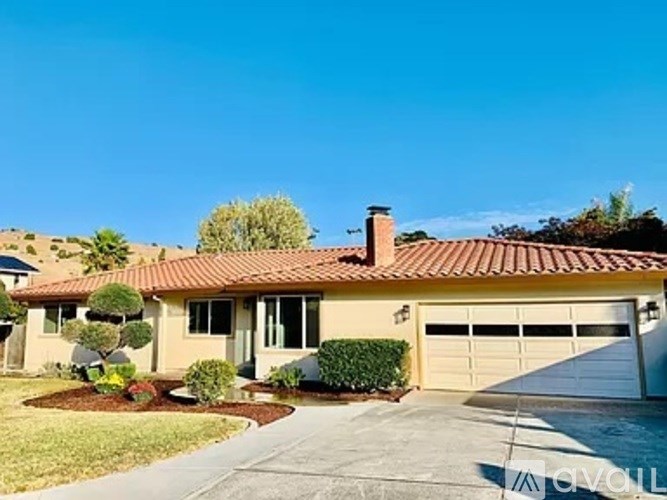 A house with a red tile roof and a white garage door.