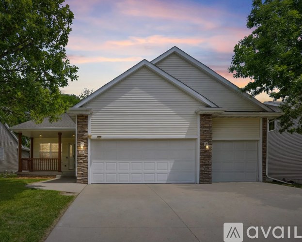 A house with a white garage door is for sale.