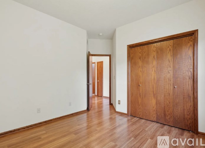 A room with a wooden floor and a wooden door.